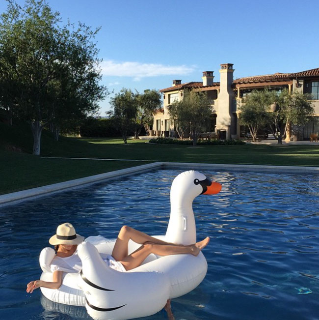 Kourtney Kardashian chilling in her giant pool swan